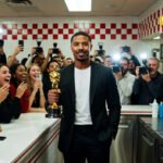Michael B. Jordan celebrating his Best Actor Oscar win for 'Sinners' with a burger at an In-N-Out restaurant.